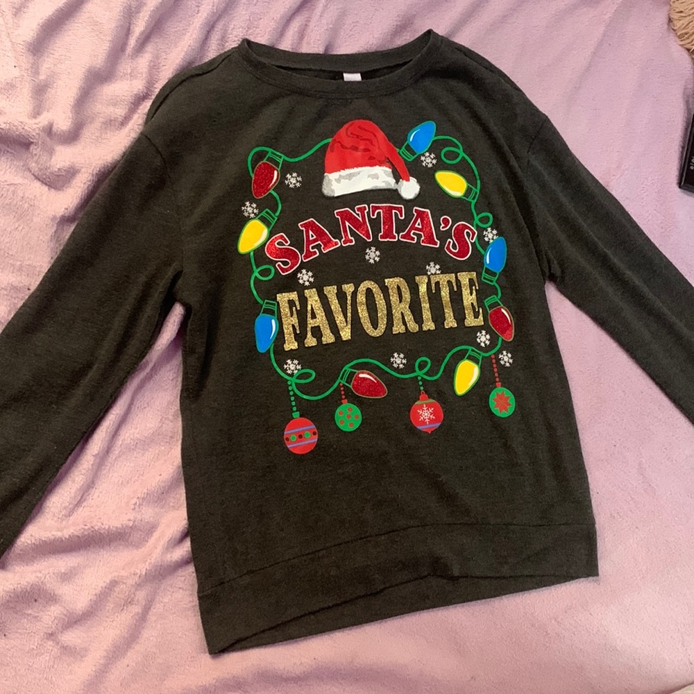 A black long sleeve shirt that’s says Santa’s favorite